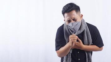 Young Asian Man Wearing Mask Suffering from Chronic Cough on White Background photo