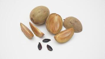 Set of Sapodilla Fruit with Its Seeds on White Background photo