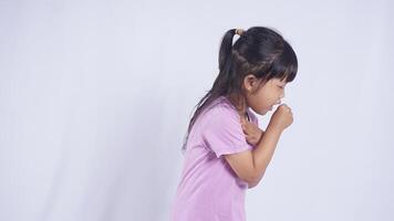 Side View of Asian Little Girl Suffering from Severe Cough on White Background photo