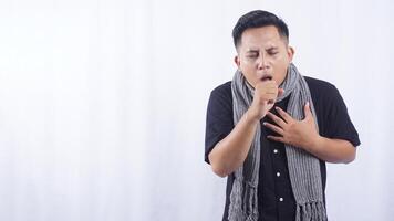 Young Asian Man Suffering from Acute Cough on White Background photo