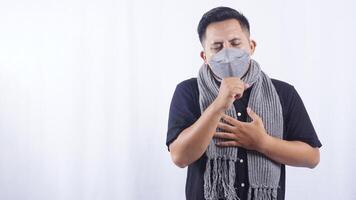 Young Man Wearing Mask with Acute Cough on White Background photo