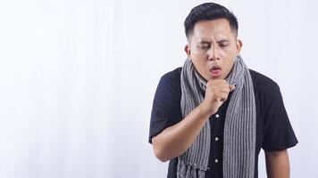 Young Asian Man Suffering from Cough on White Background photo