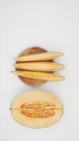 Top View of Half and Sliced Cantaloupe Melon on White Background photo