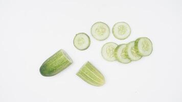 Half and Slices of Cucumber on White Background photo