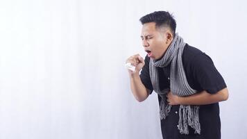 Young Asian Man with Scarf Coughing on White Background photo