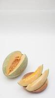 Cantaloupe Melon and Sliced on Wooden Plate on White Background photo