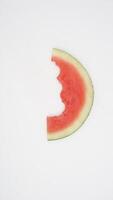 Slice of Fresh Watermelon with Bites on White Background photo