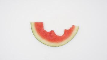 Slice of Ripe Watermelon with Bites on White Background photo