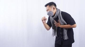 Side View of Young Man Wearing Mask Suffering from Acute Cough on White Background photo