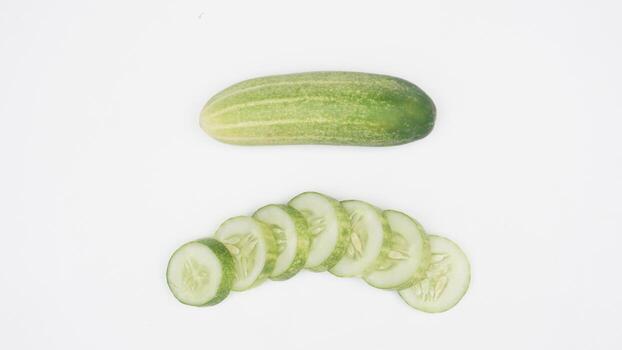 Fresh Raw and Slices of Cucumber on White Background photo