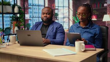 Independent people using devices for their remote job tasks at home, surrounded by digital tools and enjoying the benefits of schedule flexibility. Modern freelancing lifestyle. Camera B. video