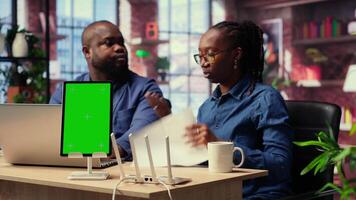 Black man and woman getting angry at home internet next to mockup screen, identifying weak connection and testing different troubleshooting techniques to fix their network errors. Camera B. video