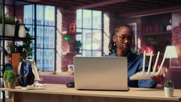 African American woman rebooting the wi fi modem by pulling out cables, checking with the internet provider for support. Troubleshooting ongoing Wi Fi connectivity issues. Camera B. video