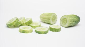 Half and Sliced Cucumber on White Background photo