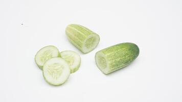 Fresh Half and Sliced Cucumber on White Background photo