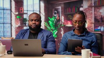 Independent people using devices for their remote job tasks at home, surrounded by digital tools and enjoying the benefits of schedule flexibility. Modern freelancing lifestyle. Camera B. video