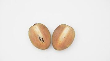 Two Sliced Sapodilla Fruit on White Background photo