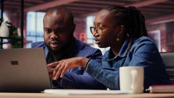 Tech savvy people working on a wireless laptop to test a new software, navigating new digital tools and managing virtual tasks. Connected and productive lifestyle at home. Camera B. video
