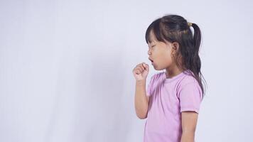 Side View of Asian Little Girl Coughing on White Background photo