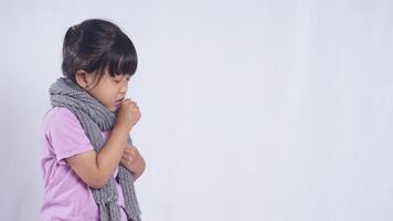 Side View of Unhealthy Asian Kid Girl with Scarf Coughing on White Background photo