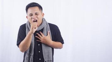 Young Asian Man Suffering from Chronic Cough on White Background photo