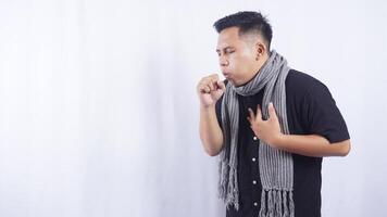 Side View of Young Asian Man Coughing on White Background photo