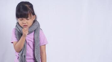 Asian Little Girl with Scarf Coughing on White Background photo