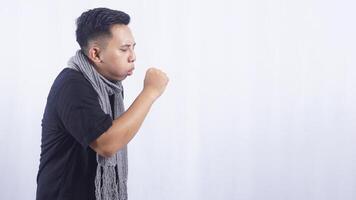 Side View of Young Asian Man Suffering from Acute Cough on White Background photo