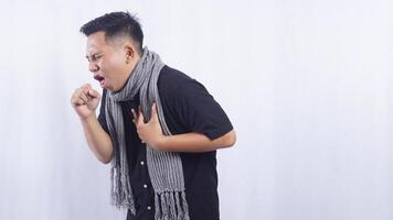 Side View of Young Asian Man Feeling Chills and Suffering from Cough on White Background photo