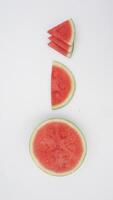 Cut, Half, and Wedges of Watermelon on White Background photo