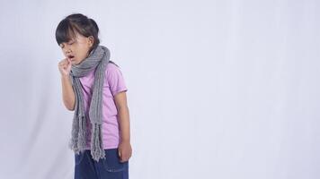 Asian Kid Girl with Scarf Coughing on White Background photo