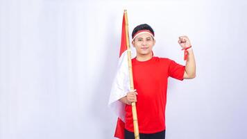 Portrait of Indonesian Man with Red and White Ribbons on His Wrist on White Background photo