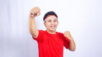 Excited Indonesian Man Celebrate Independence Day of Indonesia on White Background photo