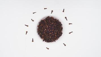 Dried Cloves Spice on Plate on White Background photo