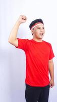 Handsome Indonesian Man with Red and White Ribbons Tied to His Head on White Background photo