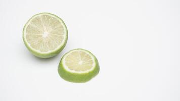 Green Lime Fruit Half and Sliced on White Background photo