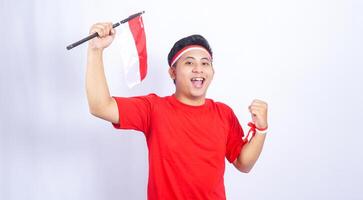 Portrait of Indonesian Man with Red and White Ribbons Showing Yes Gesture Celebrate Independence Day of Indonesia on White Background photo