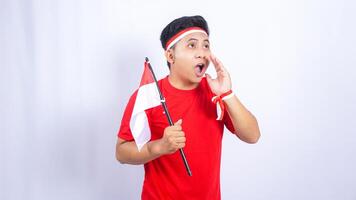 Indonesian Man with Red and White Attribute to Celebrate Independence Day of Indonesia on White Background photo