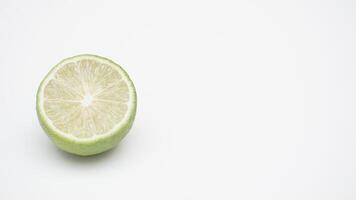 Half of Green Lime Fruit on White Background photo