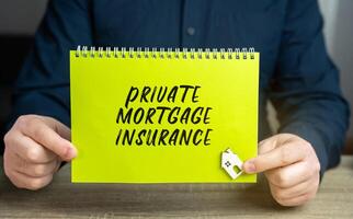 Private mortgage insurance concept. This is the mortgage type in which down payment or equity position is less than 20 percent of the property value. Business and finance. Notebook and businessman photo