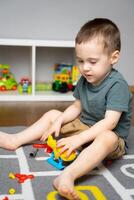 A little toddler boy 2.5 years is playing with a toy helicopter photo