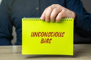 Unconscious bias concept - attitudes or stereotypes that affect our understanding, actions, and decisions in an unconscious manner. Implicit bias. Social norms or cultural influences. Man and notes photo