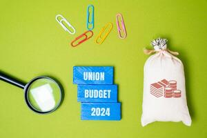 Union budget 2024 concept. Annual financial statement presented by the government of a country, detailing its expected revenue and expenditure for the next year. Business and finance. Money bag blocks photo