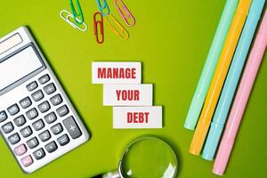 Manage your debt concept. Strategically vision and repaying borrowed money to maintain financial stability and avoid excessive interest or penalties. Inscription on the blocks. Business and finance photo