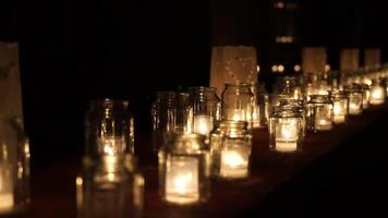 Glowing candles spread calm ambiance across quiet darkness, calm aura enveloping flickering lights, calm comfort uplifting weary viewers seeking gentle, relaxing warmth in deep, peaceful shadows video
