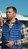 Truck driver using radio walkie talkie communication in parking video