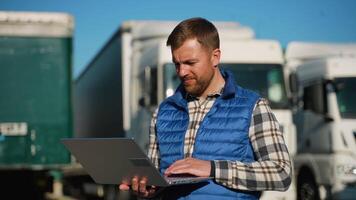 Logistics worker managing fleet operations on laptop video