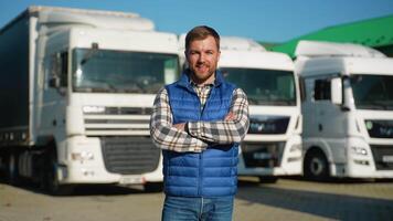 Confident truck driver standing by fleet video