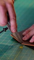 Craftsman Using a Compass to Mark Leather for Precise Cutting video