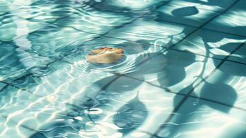 A serene floating object in a tranquil swimming pool reflecting sunlight and shadows photo